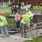 students pouring concrete